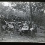 Missionaries and a group of locals eating together