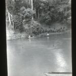 A river with boats and locals on either side