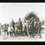 Locals holding an ivory tusk with a Dutch trader