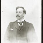 Portrait of Reverend Stephens, well dressed in suit with short hair and moustache