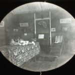 View of Mrs Howell's living room with rugs, religious messages on the wooden walls and a small piano