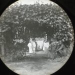 Locals pictured through an overhead frame of passionfruit plants