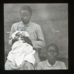 A baby infant with two local nurses