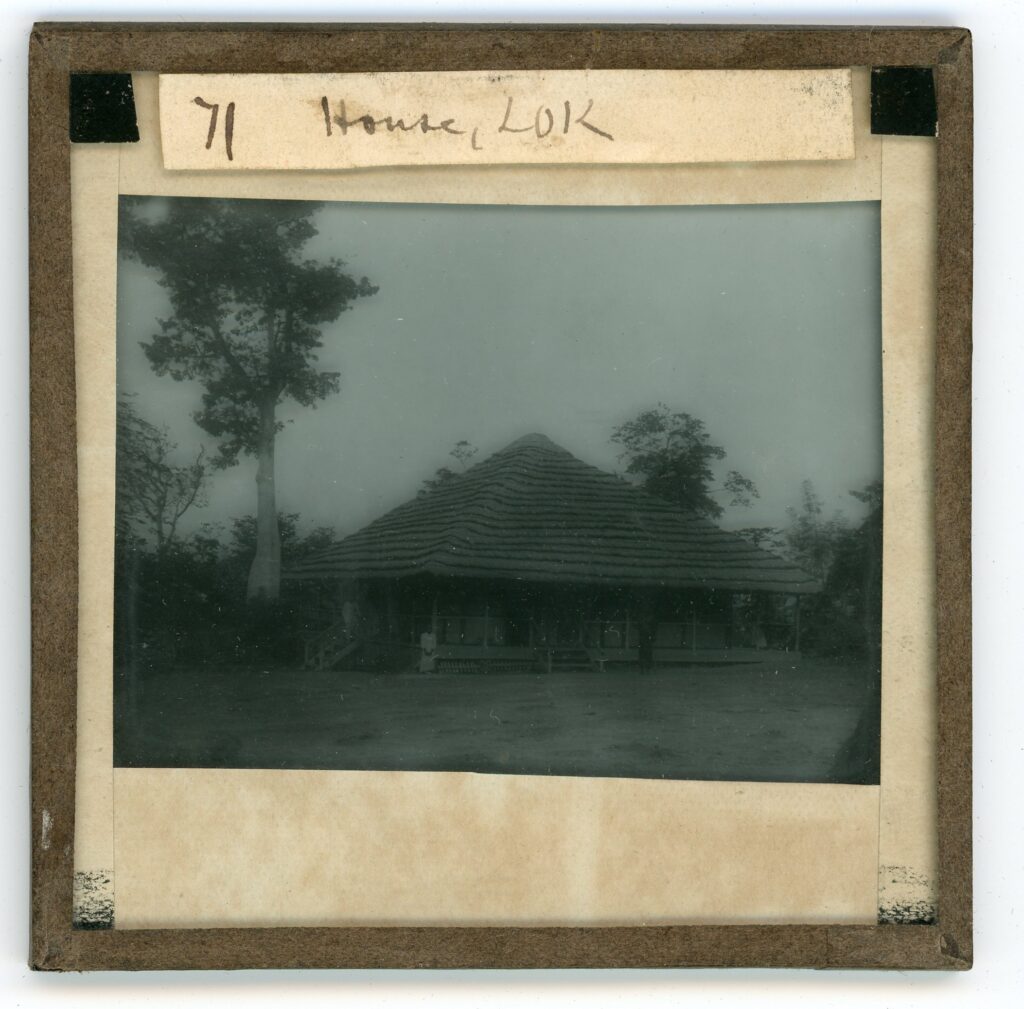 A single-storey straw-roofed house with a veranda