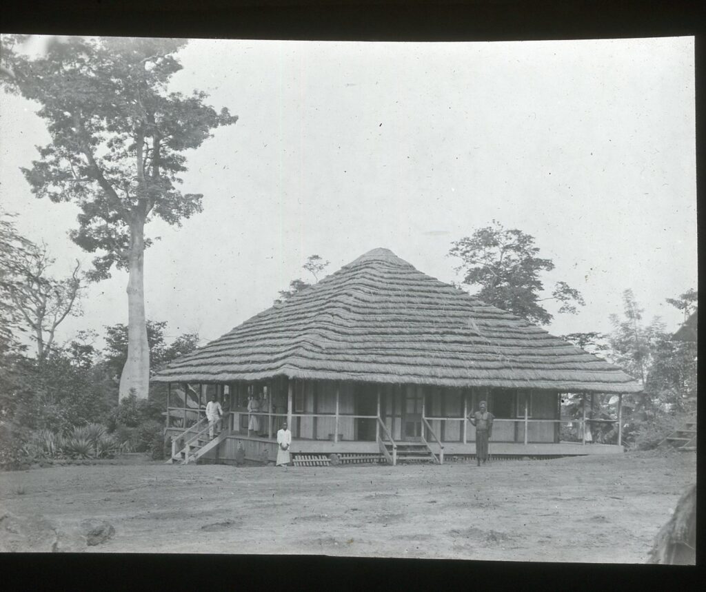 A single-storey straw-roofed house with a veranda