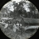 A group of locals assembled in a jungle clearing