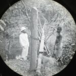 A missionary and a local by a simple wooden plank bridge