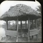 View of a hexagonal summer house by a body of water