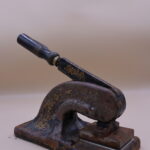 Hand-operated embossing machine, black with gilded leaf decoration