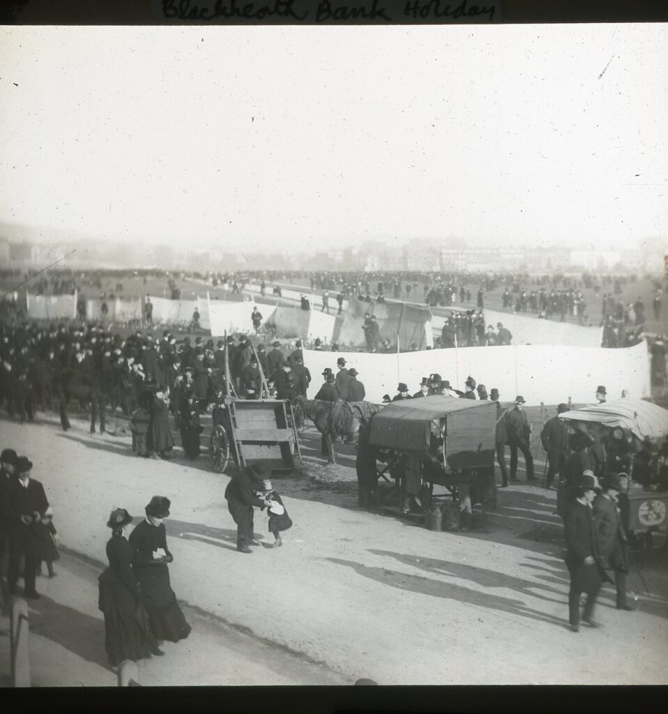 Slide showing an image of Edwardian crowds gathered around tents on Blackheath green