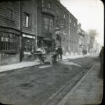 Slide showing a pony-drawn cart parked outside a brick pub, with a view of brick terraced housing down the street