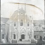 Slide showing a large neo-gothic chapel with spire-topped buttresses and arched portals