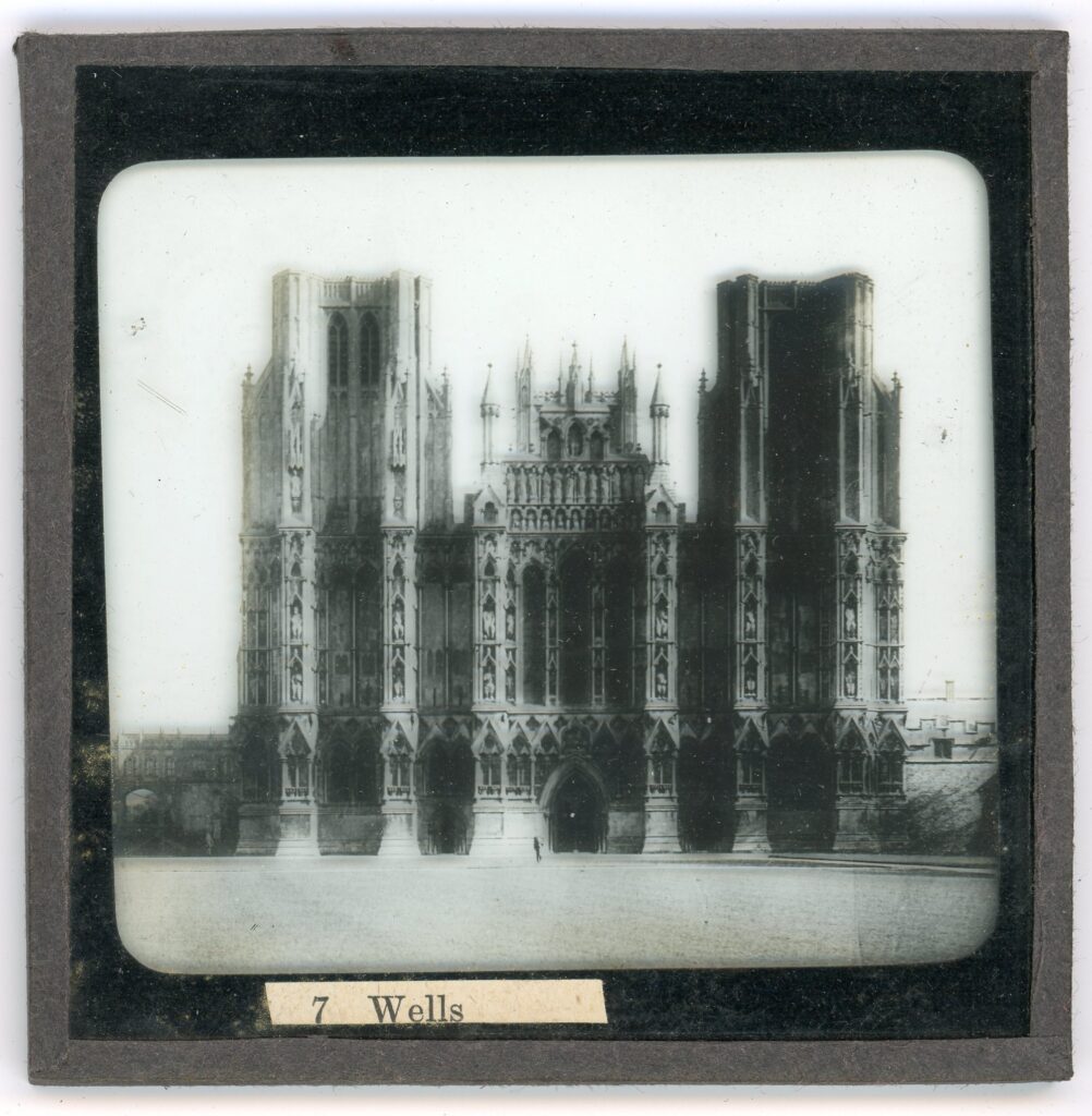 Slide showing the two towered frontage of the gothic cathedral of Wells with butresses featuring alcoves containing statues
