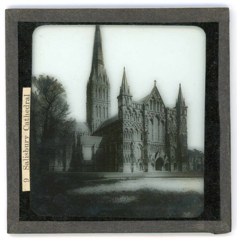 Slide showing the frontage and single spired tower of the gothic Salisbury cathedral featuring alcoves of statued figures