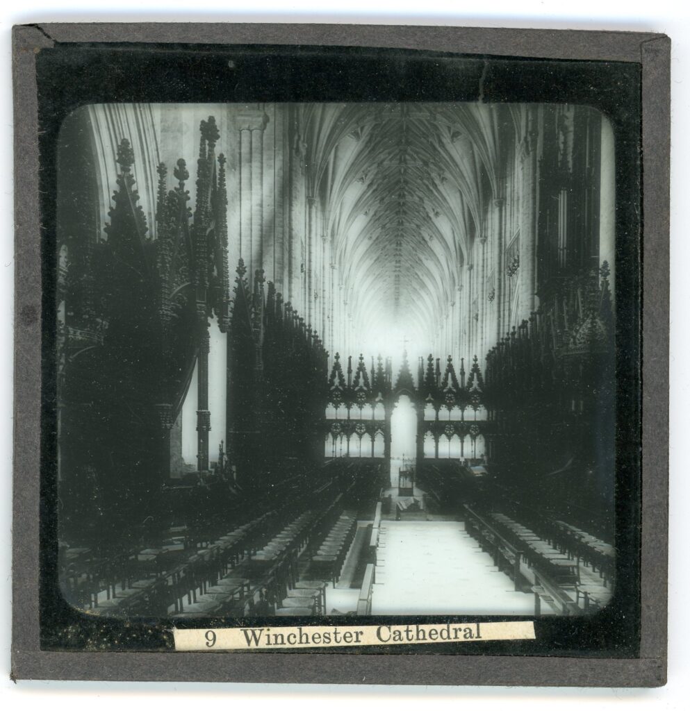Slide showing an aisle of Winchester cathedral with ribbed vaulted ceiling above