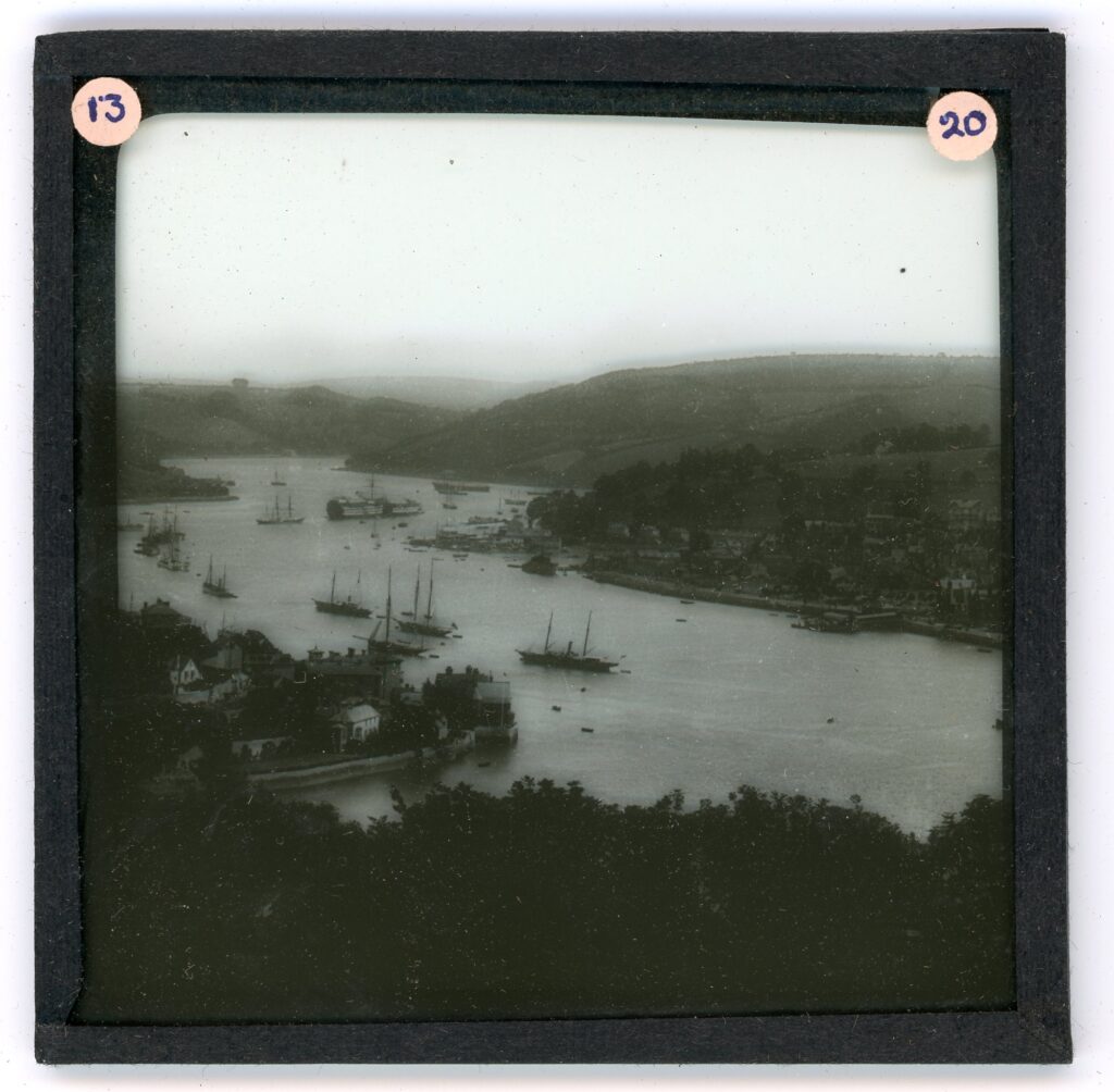 Slide showing a view of an inland harbour with large sailing ships