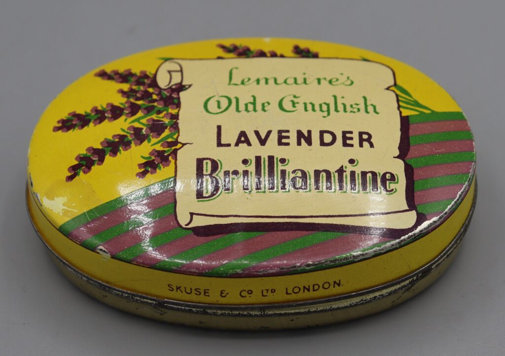 Oval metal tin view of multicoloured lid