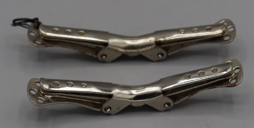 Two metal collar clips, back view, clips closed