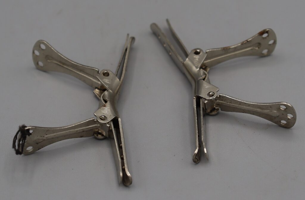 Two metal collar clips, full view, clips open