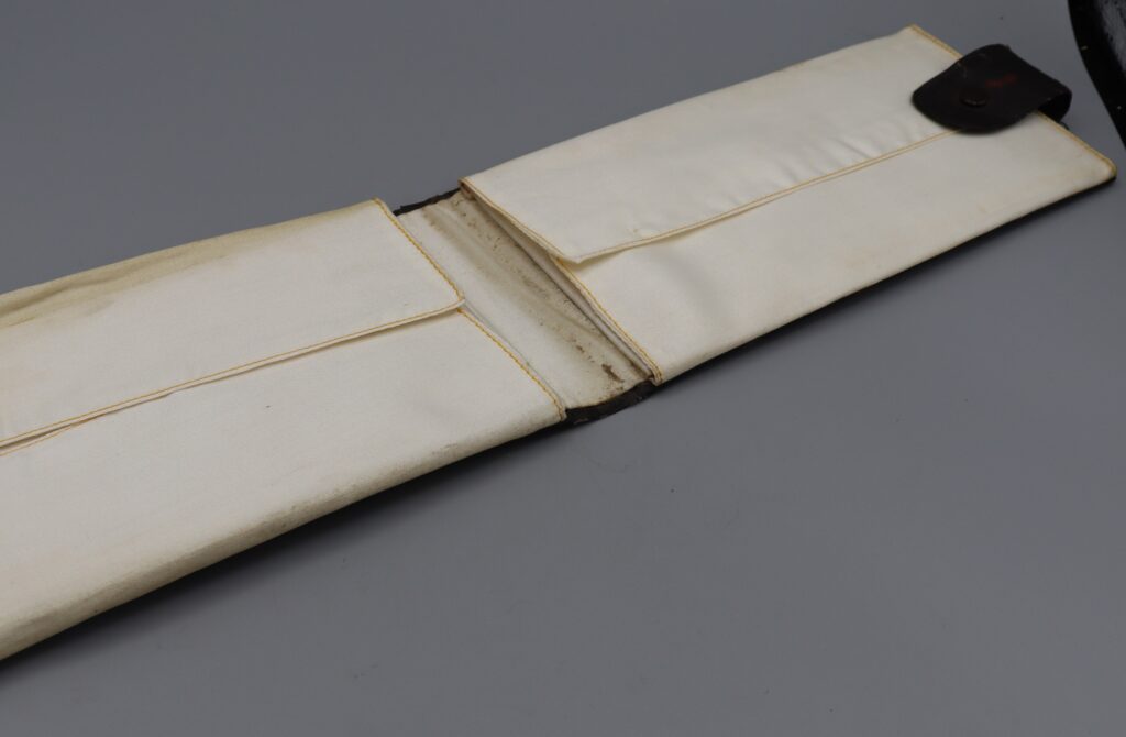 Leatherette collar holder fully open, displaying silk lining