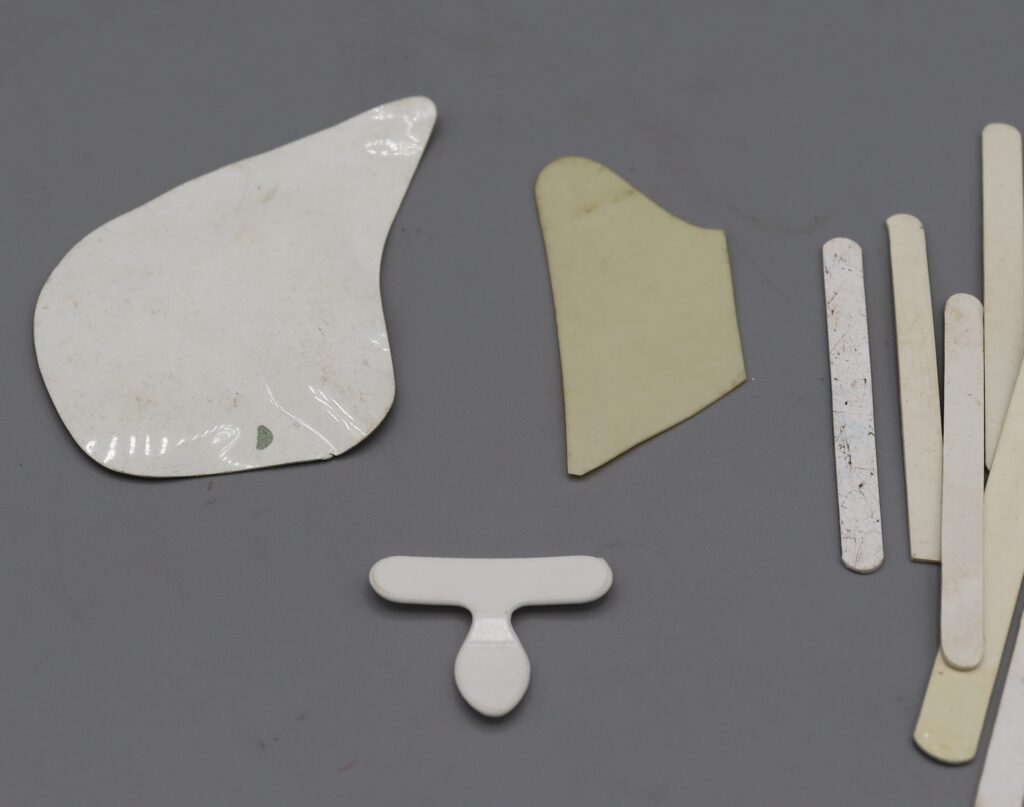 Collar stiffeners, close-up view of shaped items