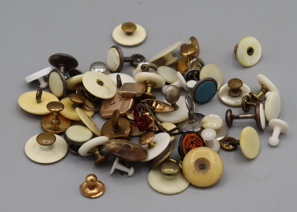Assorted collar studs and cuff-links in a heap