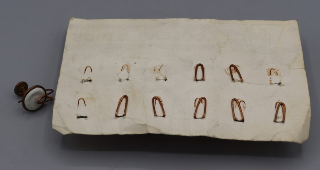 Back view of merchandising card showing the clips holding the collar studs in place