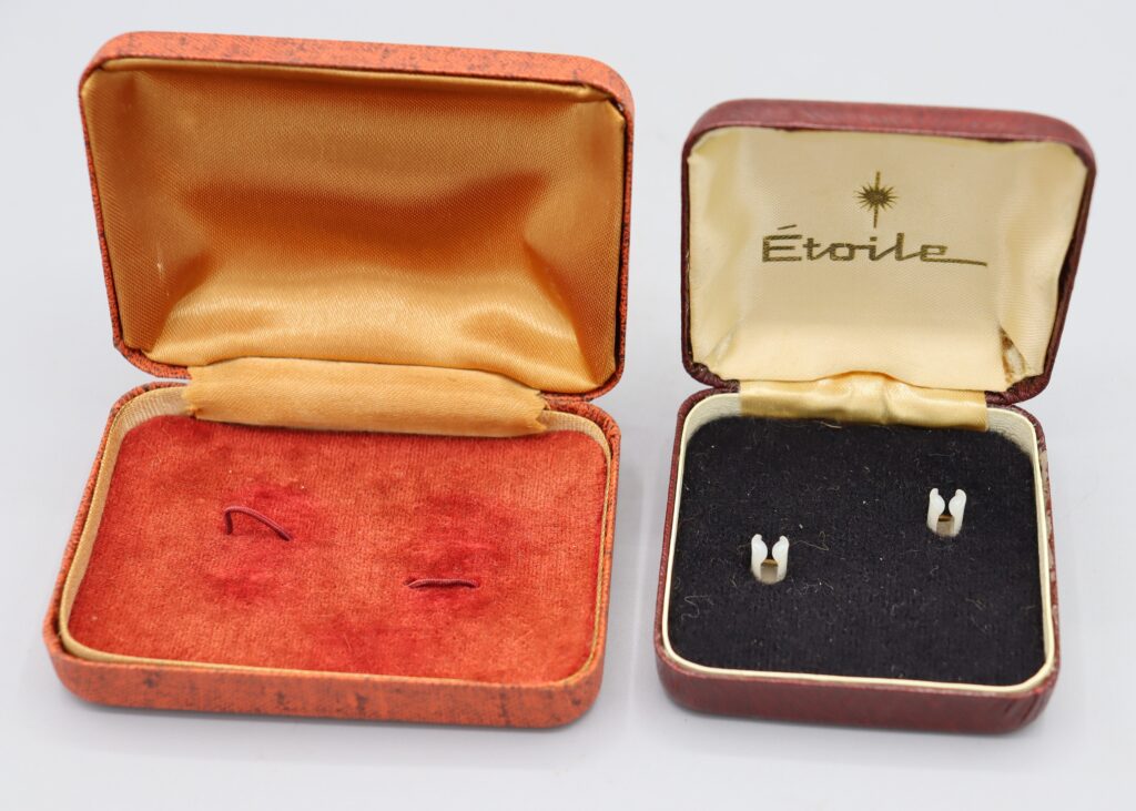 Two jeweller's boxes shown open. One has Etoile written inside the lid.