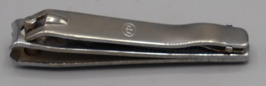 Large nail clippers, top view showing the numbers 777 stamped in the metal