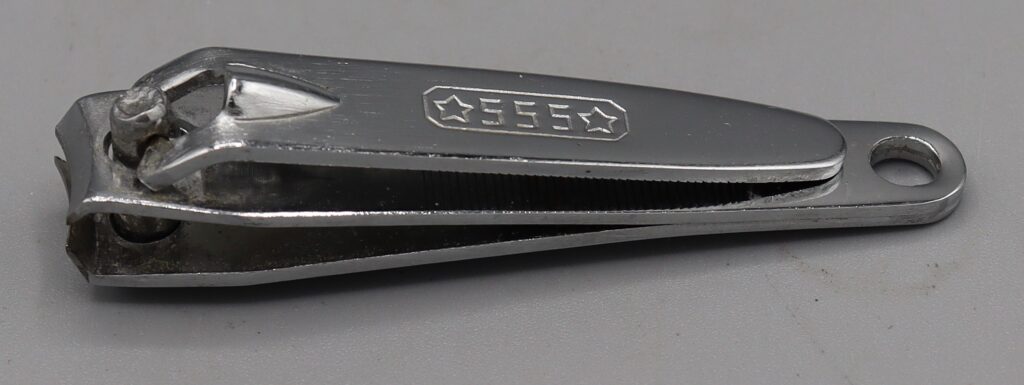 Small nail clippers, view from the top showing the numbers 555 stamped in the metal