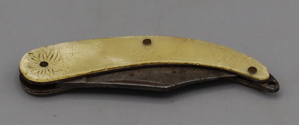 Folded penknife shown on left side