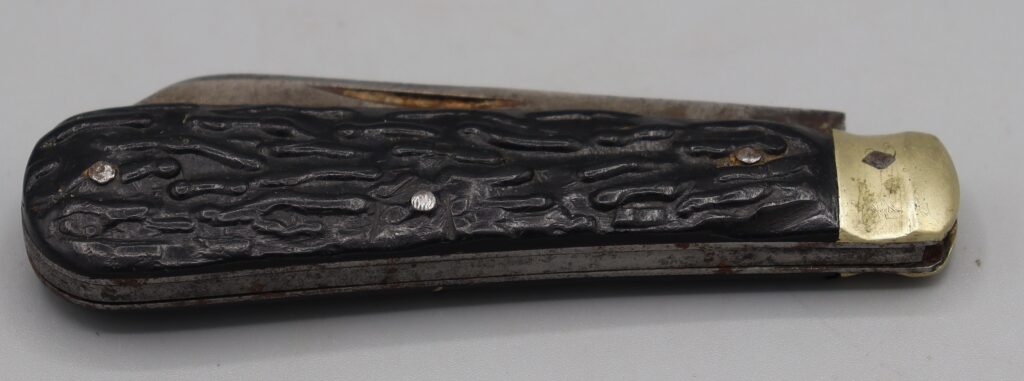 Brown handled penknife shown in closed position side view