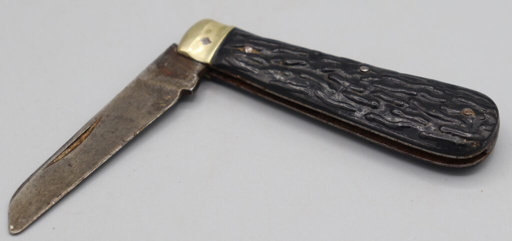 Penknife with brown handle, shown partially open