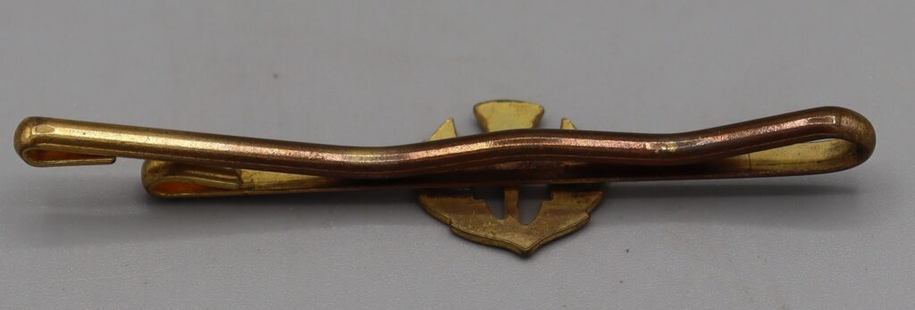 Gold tone metal tie clip, reverse side upward