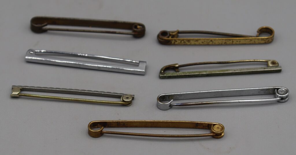 Group of seven plain metal tie pins