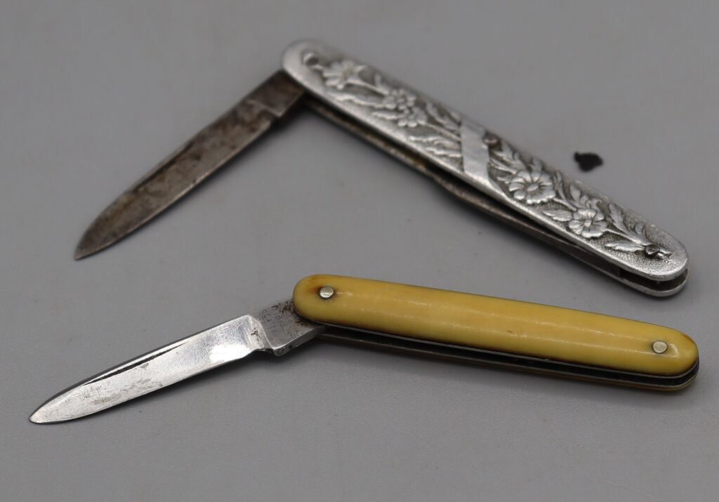 Two small penknives shown partially open