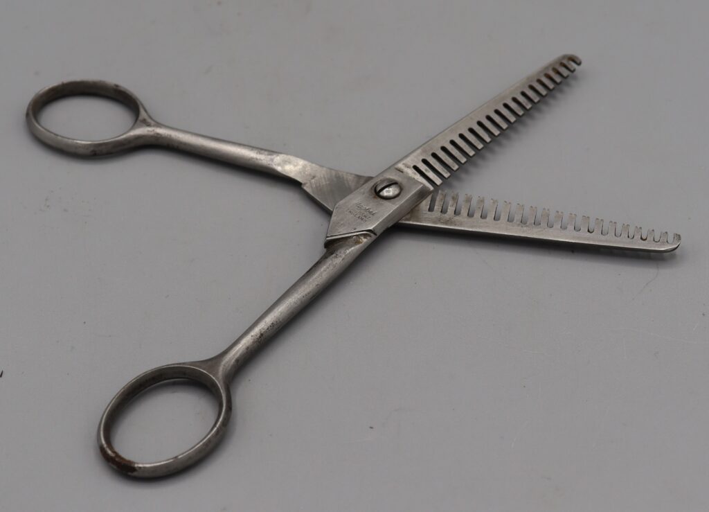 Pair of hairdressers thining scissors, shown in open position