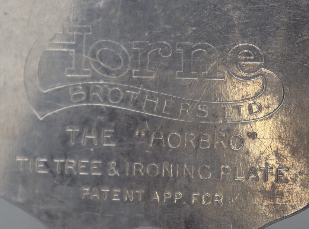Close up view of writing engraved on the tie ironing plate