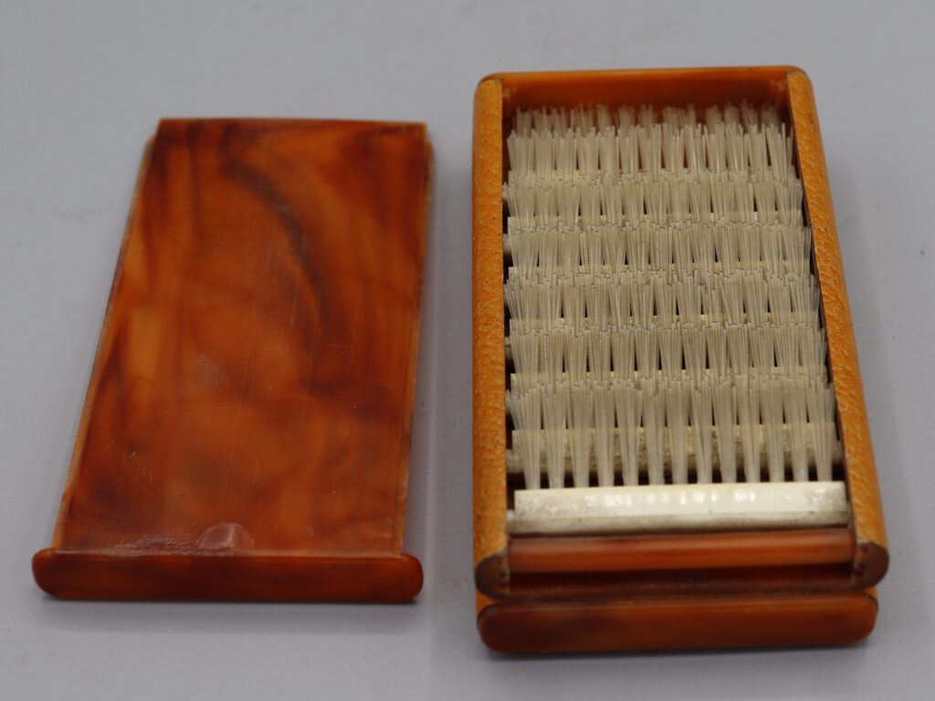 Box open to show fold-up hairbrush