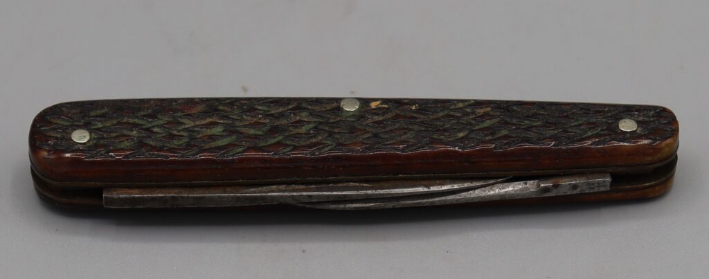 Twin bladed penknife, shown closed blade side at the front