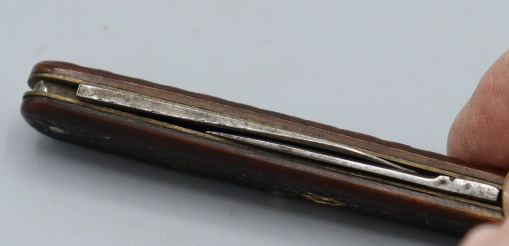 Twin blade penknife, shown closed, side view