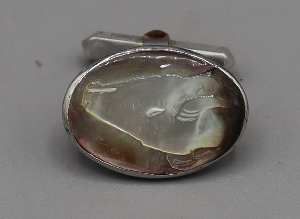 Single cufflink, showing abalone inlaid head
