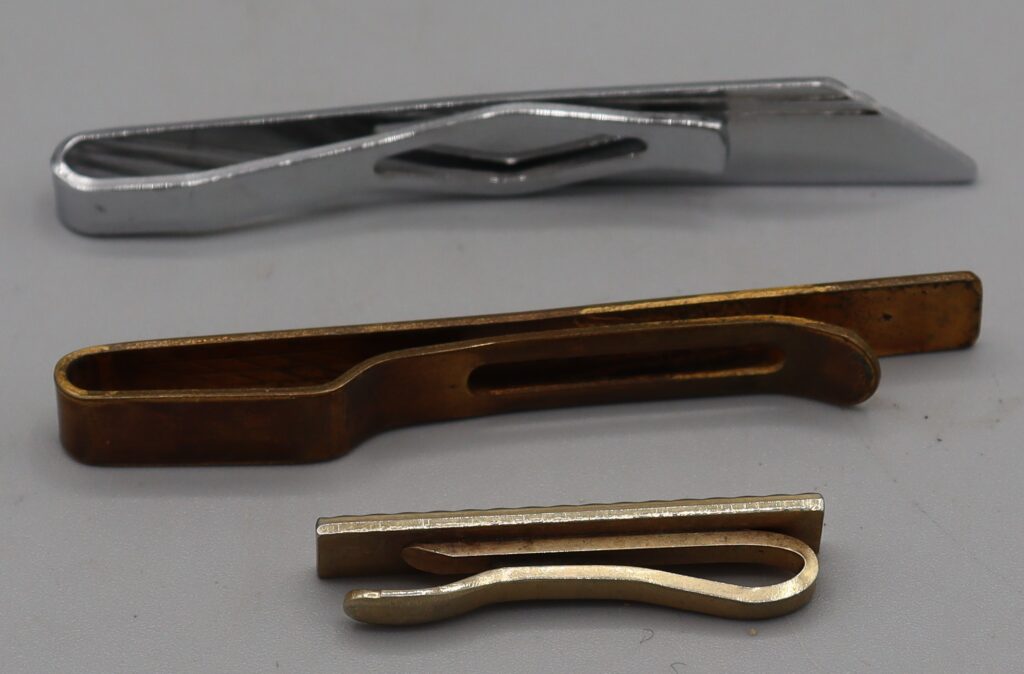 Three tie clips, side view