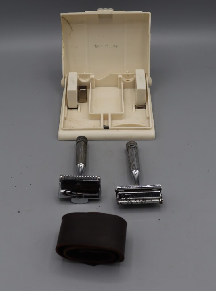 Two Everready razors spare blades & strop next to open carry case