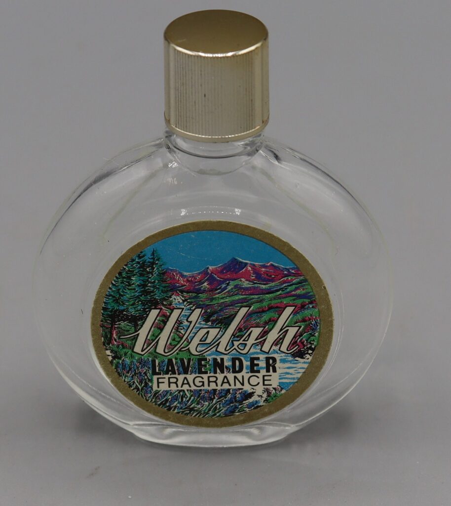 small round perfume bottle with Welsh fragrance on the label