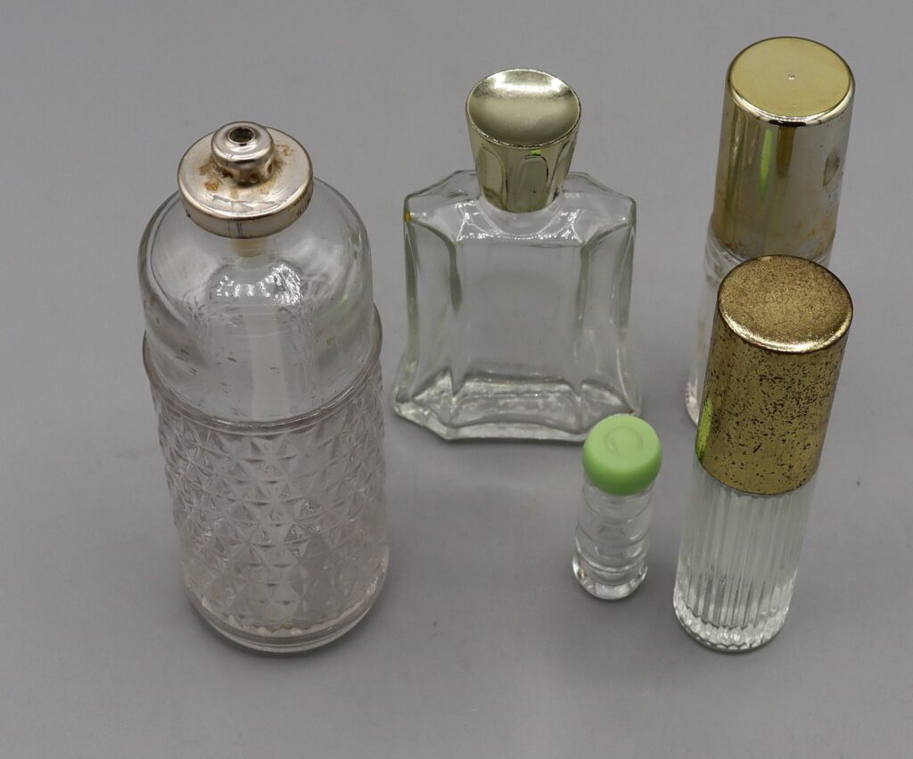 five glass perfume bottles