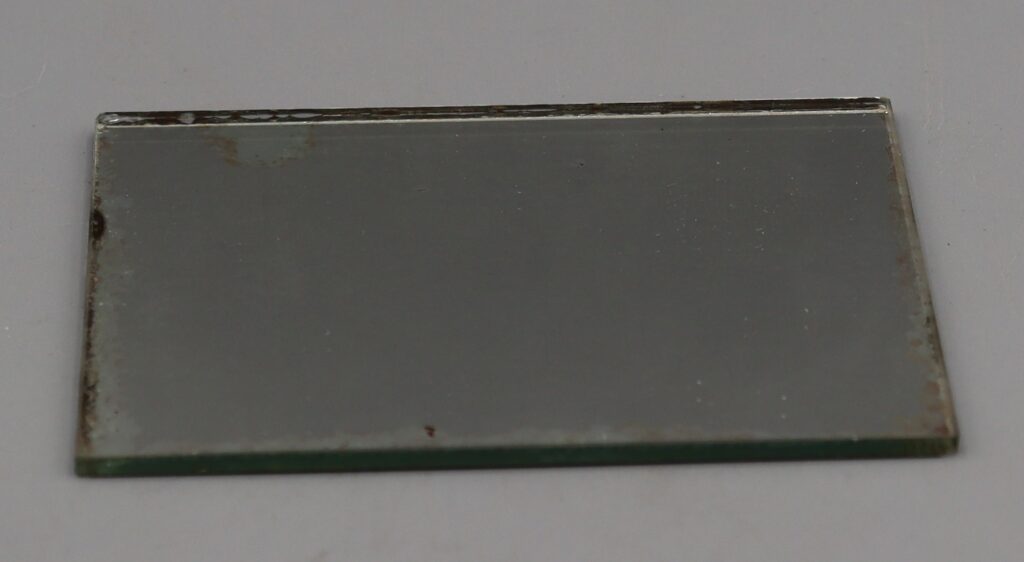 small mirror with a maroon back