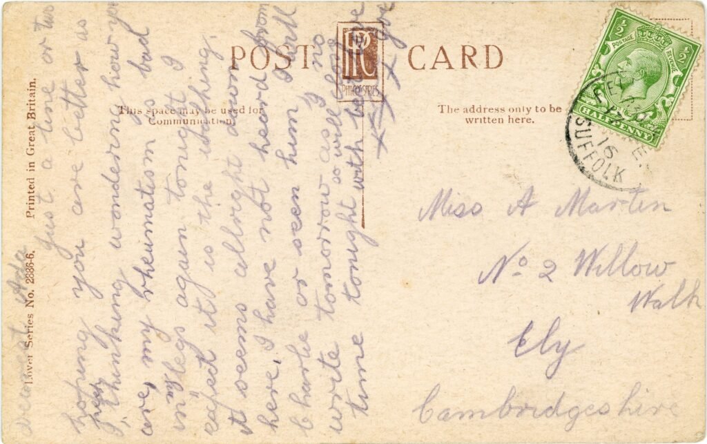 Reverse of an Edwardian postcard with a King George V stamp, circular postmark, and written correspondence in pencil