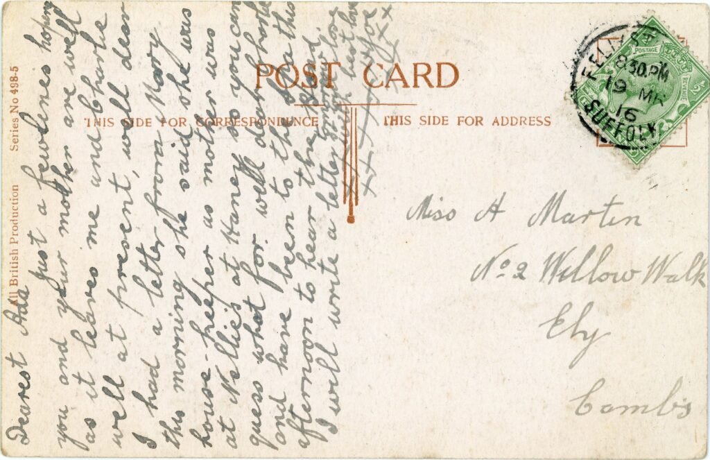 Reverse of an Edwardian postcard with a King George V stamp, circular postmark, and written correspondence in pencil