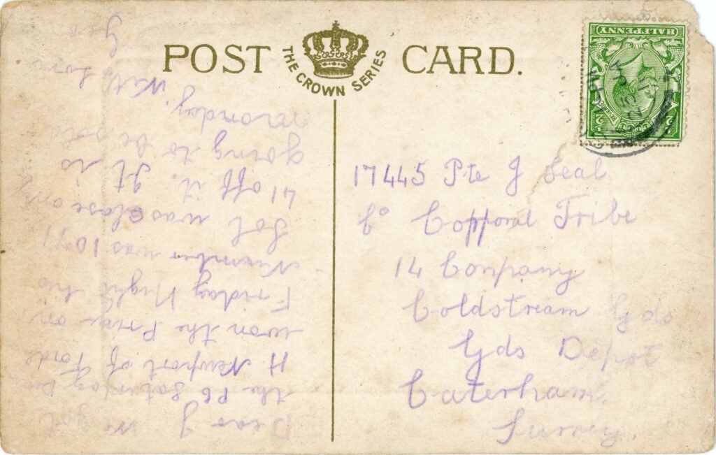 Reverse of an Edwardian postcard with upside-down Kind George V stamp, circular postmark, and written correspondence in pencil